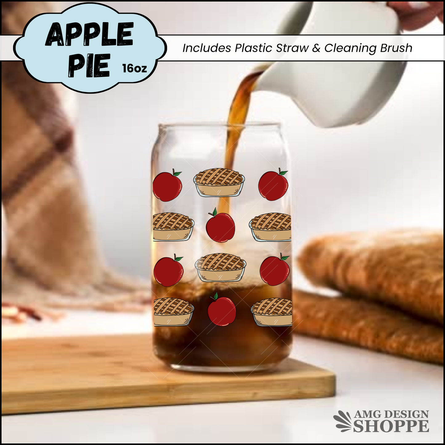 A 16oz clear glass can-shaped mug with a repeating apple pie pattern, shown with coffee being poured into it on a wooden board. 